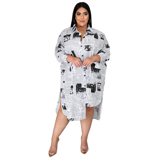 Plus size Maryangel Rebel shirt dress with a collared design and newspaper print, featuring an irregular asymmetric hem.