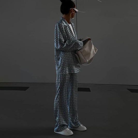 Maryangel Rebel women's long sleeve collared suit with bootleg pants and street print, styled in an urban setting.