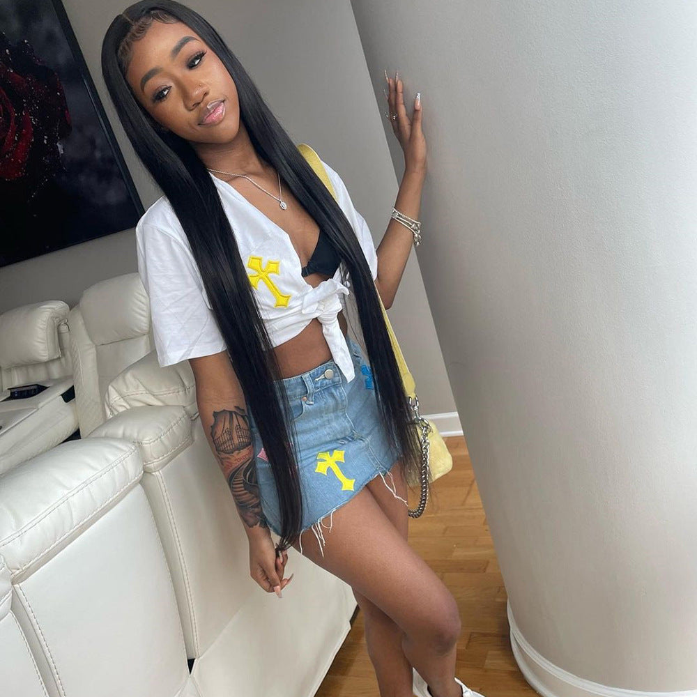 Maryangel Rebel women's denim skirt featuring tassel details, criss-cross stitching, and a floral design.