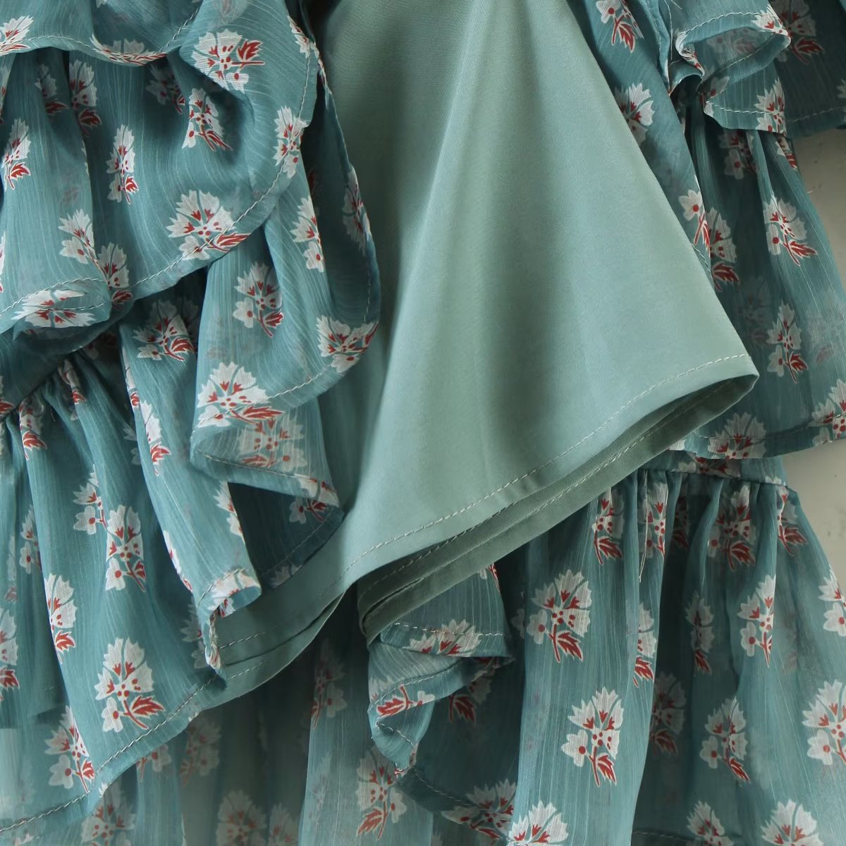 Elegant Maryangel Rebel floral chiffon dress with slim fit, square collar, and puff sleeves in a tiered design.