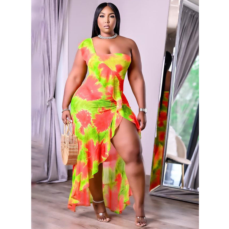 Plus size summer dress by Maryangel Rebel, featuring a single sleeve and asymmetric flounced skirt with a vibrant print.