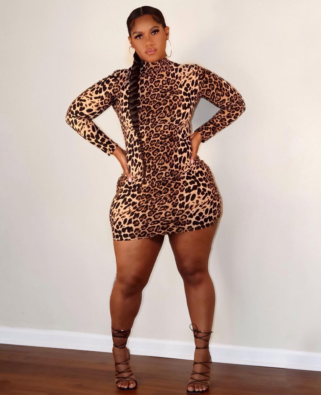 Plus size leopard print dress by Maryangel Rebel, featuring a flattering design and vibrant print on a model.