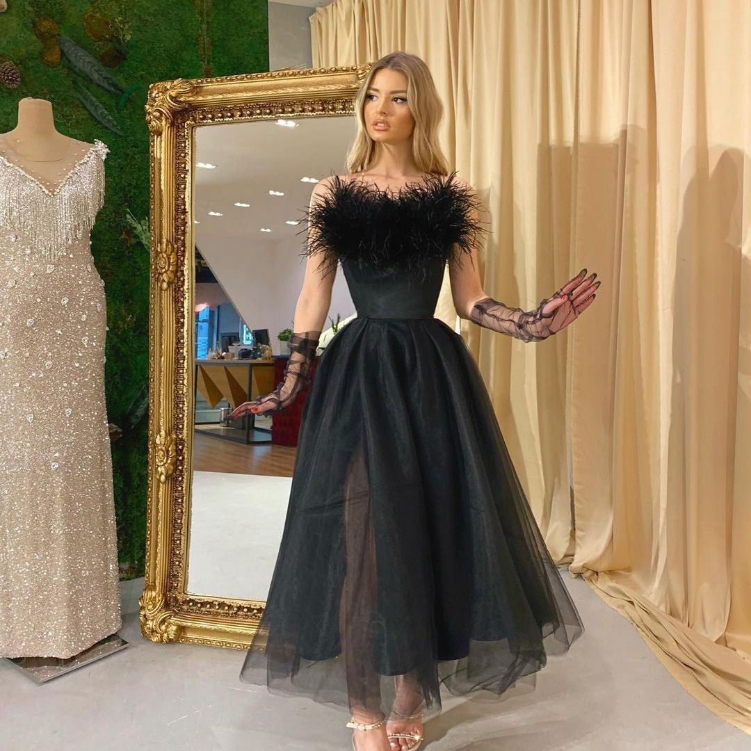 Elegant Maryangel Rebel evening dress with feather straps and tulle fabric, perfect for formal events.