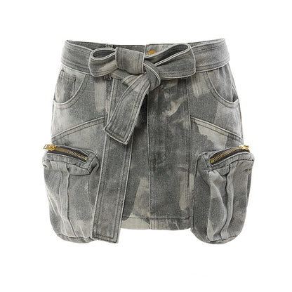 Maryangel Rebel camouflage low waist tooling skirt with three-dimensional zipper pocket and belt detail.