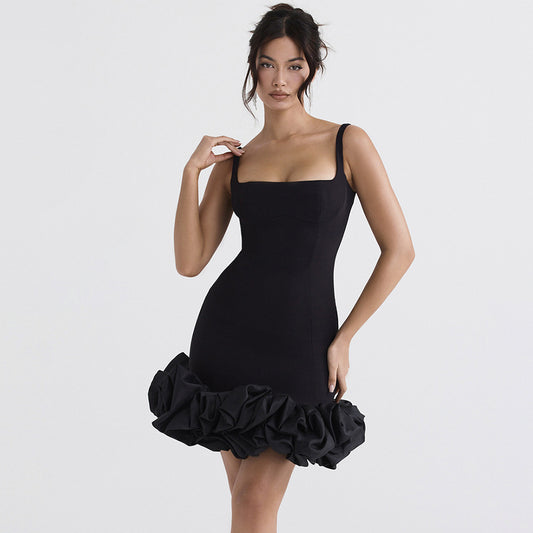 Woman modeling a black sleeveless mini dress with a square collar and 3D decoration, featuring a short length and spaghetti straps.