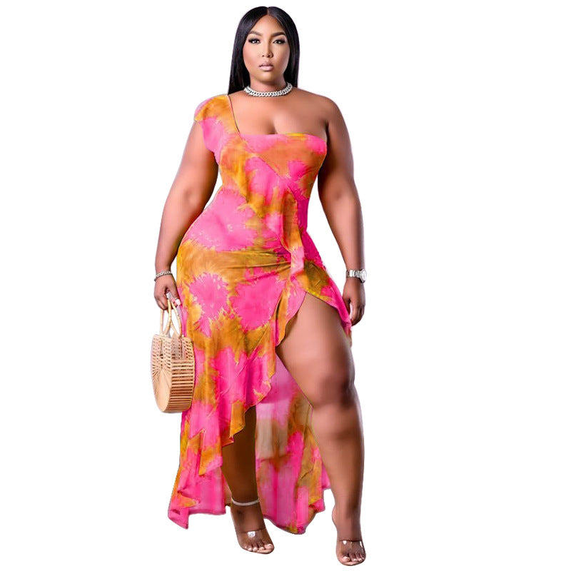 Plus size summer dress by Maryangel Rebel with single sleeve and asymmetric flounced skirt in a vibrant print.