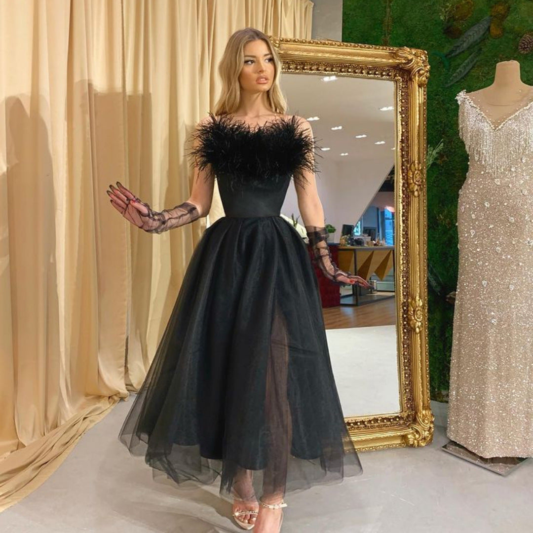 Elegant Maryangel Rebel evening dress with feather straps and tulle fabric, showcasing a sophisticated silhouette.