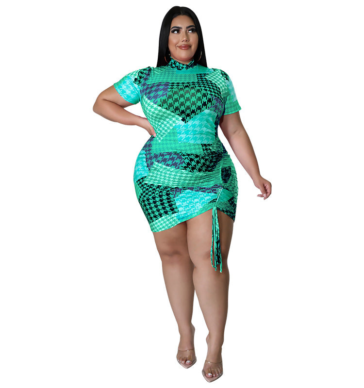 Plus size summer short-sleeved dress with a mid-skirt design by Maryangel Rebel, featuring a vibrant floral pattern.