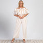 Plus size women's off-shoulder jumpsuit in solid color with lotus edge and straight-leg design by Maryangel Rebel.