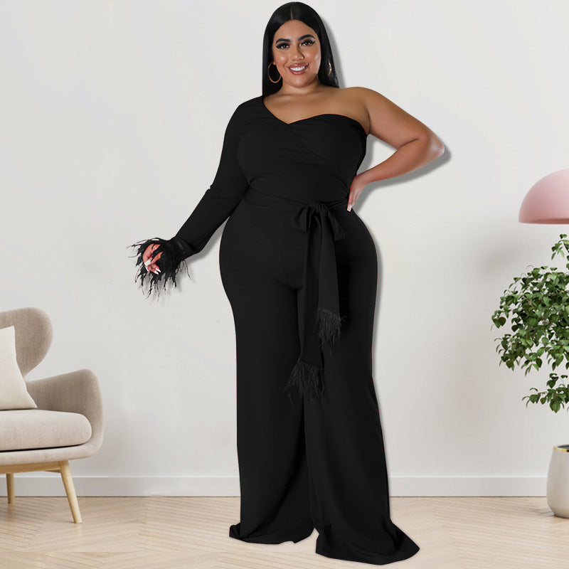 Plus size women's asymmetric jumpsuit in black, designed by Maryangel Rebel, featuring a stylish draped silhouette.