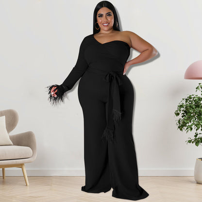 Plus size women's asymmetric jumpsuit in black, designed by Maryangel Rebel, featuring a stylish draped silhouette.