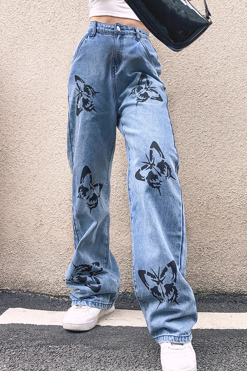 Slimming straight-leg jeans for women featuring a butterfly print by Maryangel Rebel, showcasing a drapey fit.